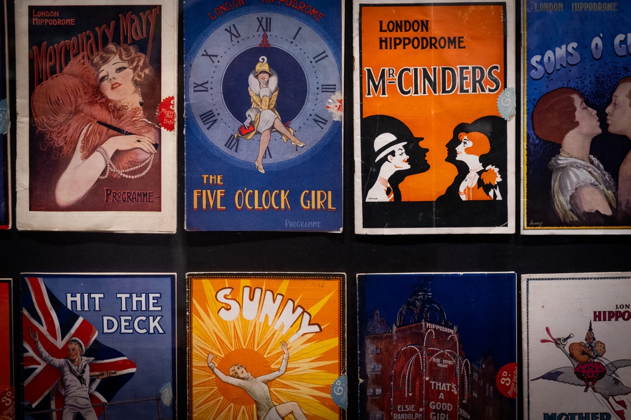 A collection of colourful vintage London Hippodrome theatre posters featuring various show titles, illustrations of performers, and bold typography, arranged in a grid on a dark background.