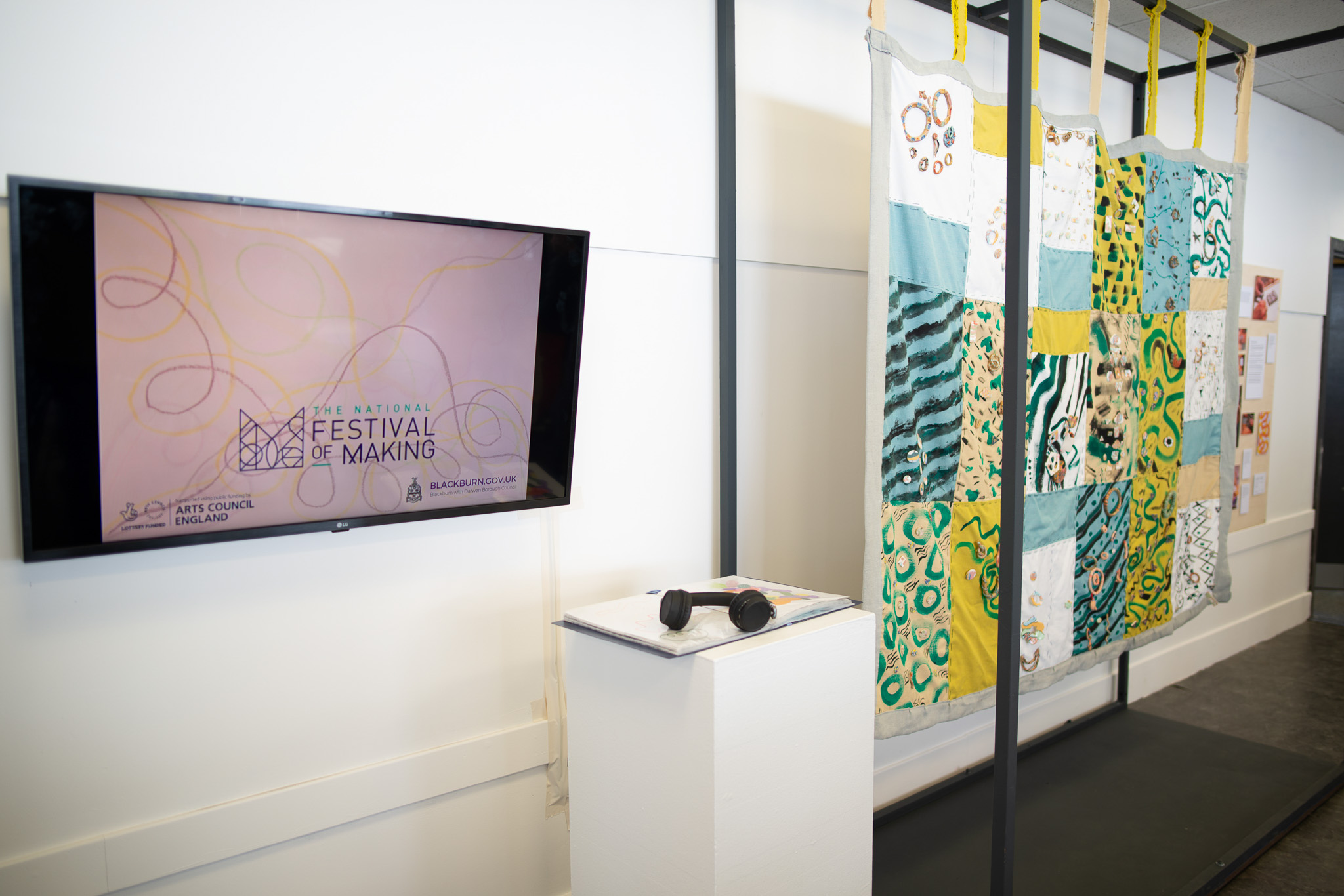 A wall-mounted TV displays 