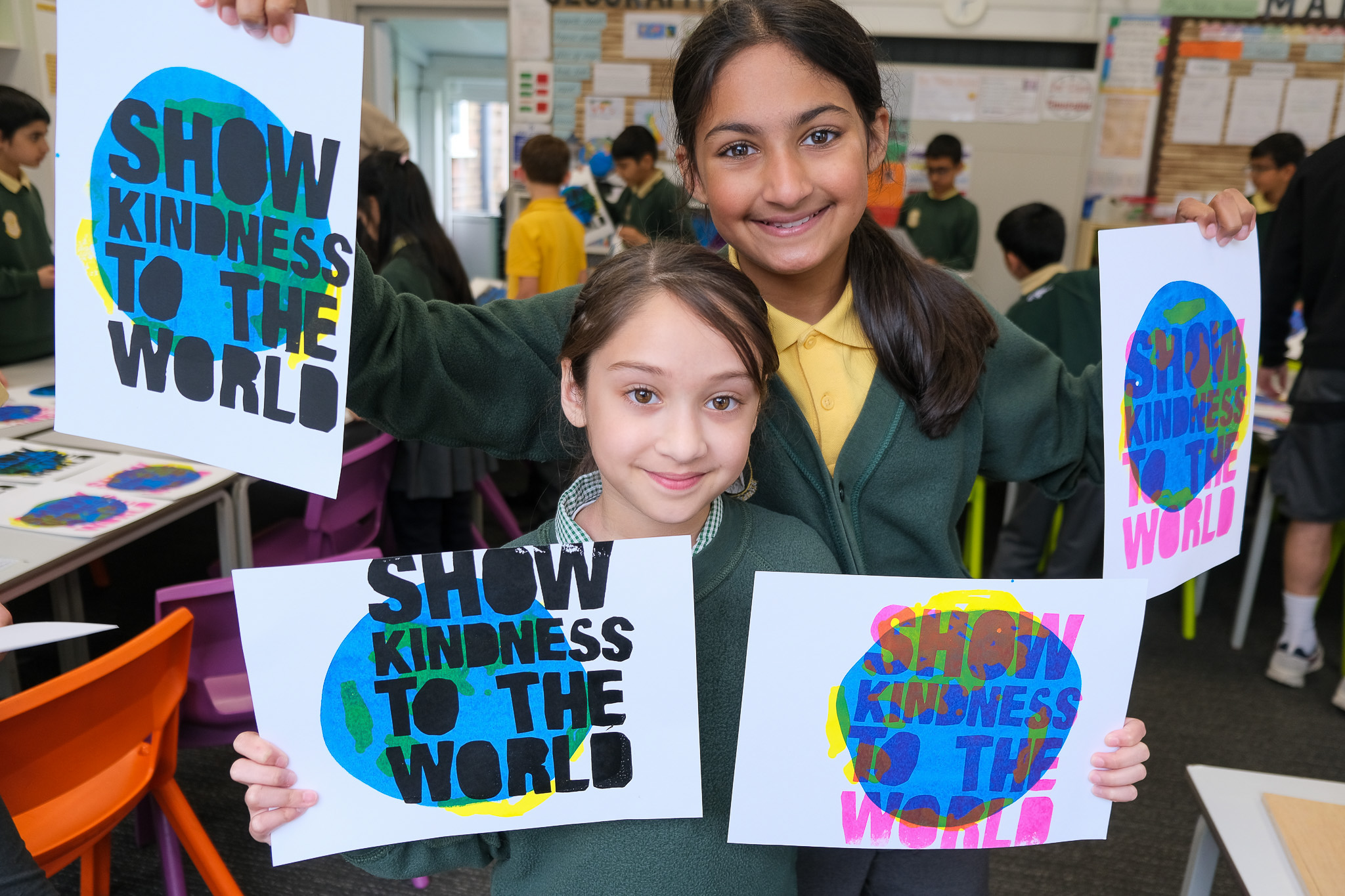 Two girls holding posters that read 