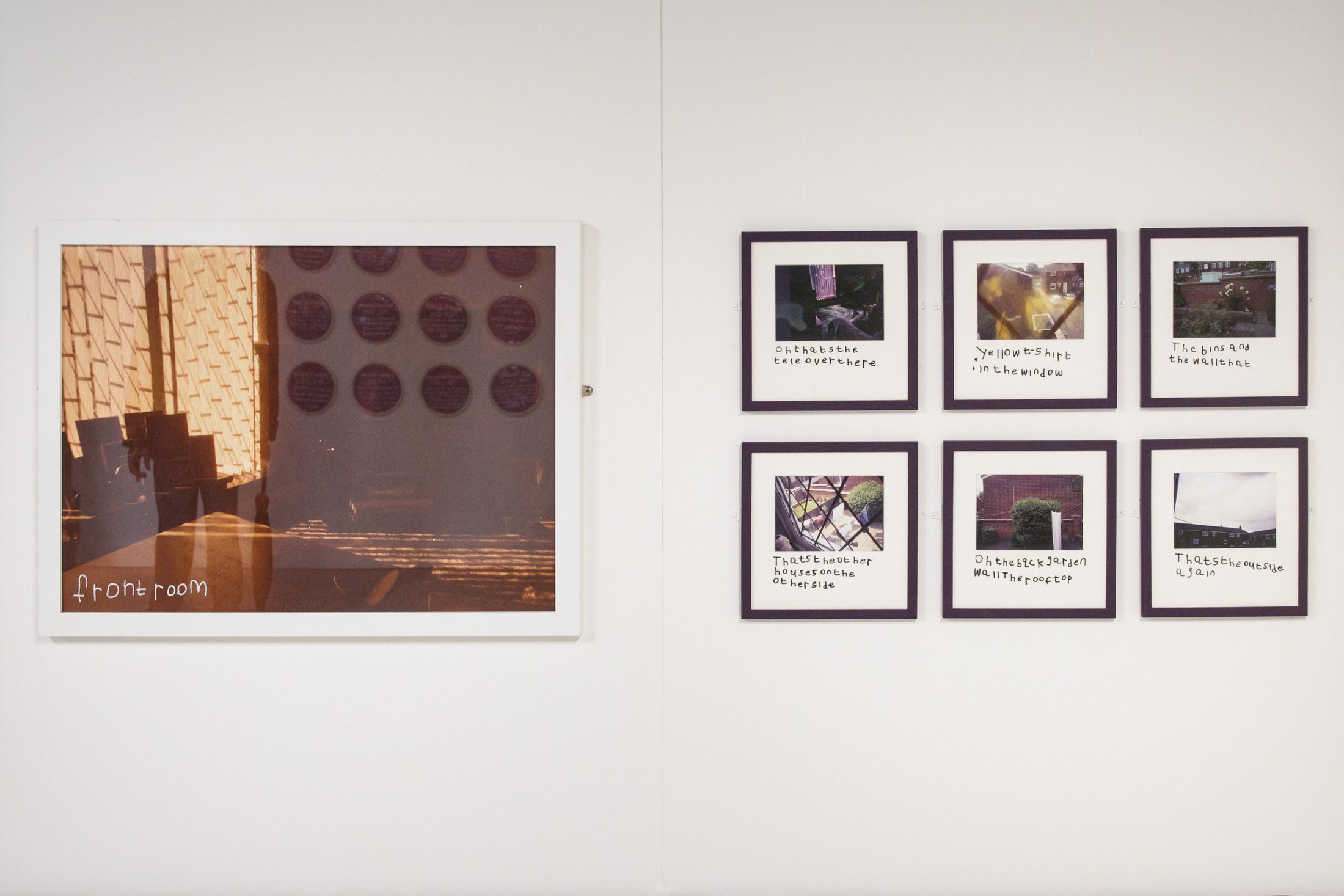 Gallery wall with a large framed photo on the left titled 