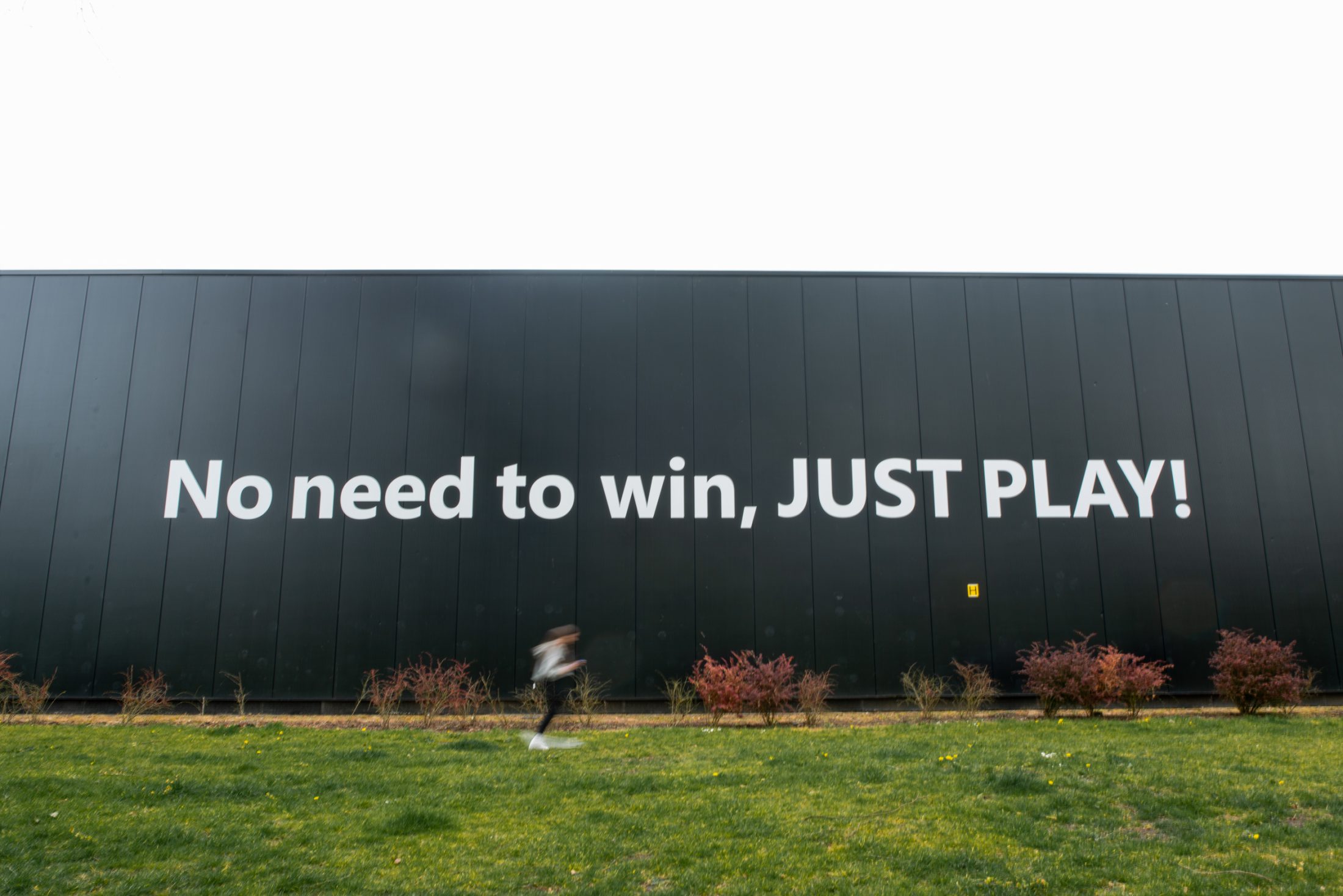 A large black wall with the white text 