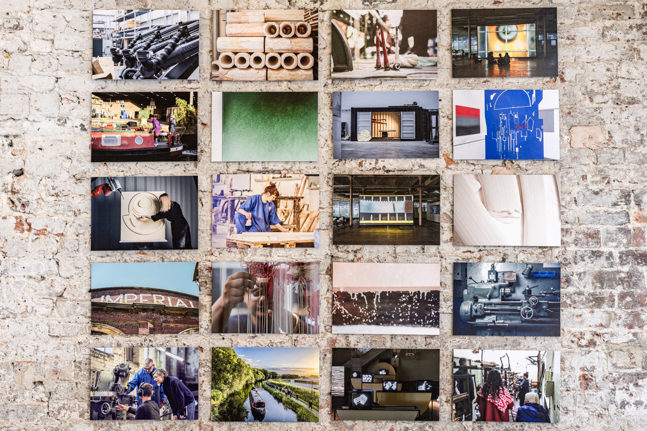 A collage of 18 colourful photographs is arranged in a grid on a textured, whitewashed brick wall, showcasing various industrial scenes, architectural details, and urban environments.