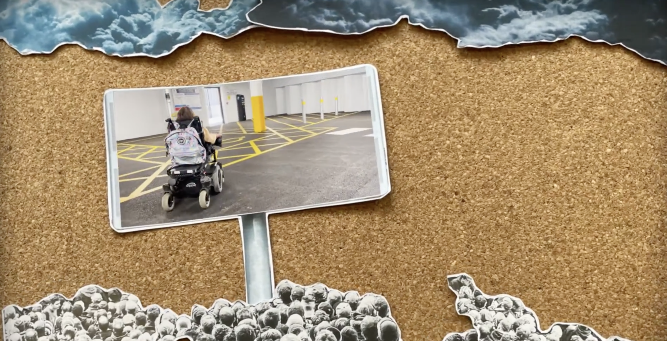 Corkboard collage with a photo of a person in a wheelchair in a parking lot. Surrounded by stormy clouds above and a black-and-white crowd below.