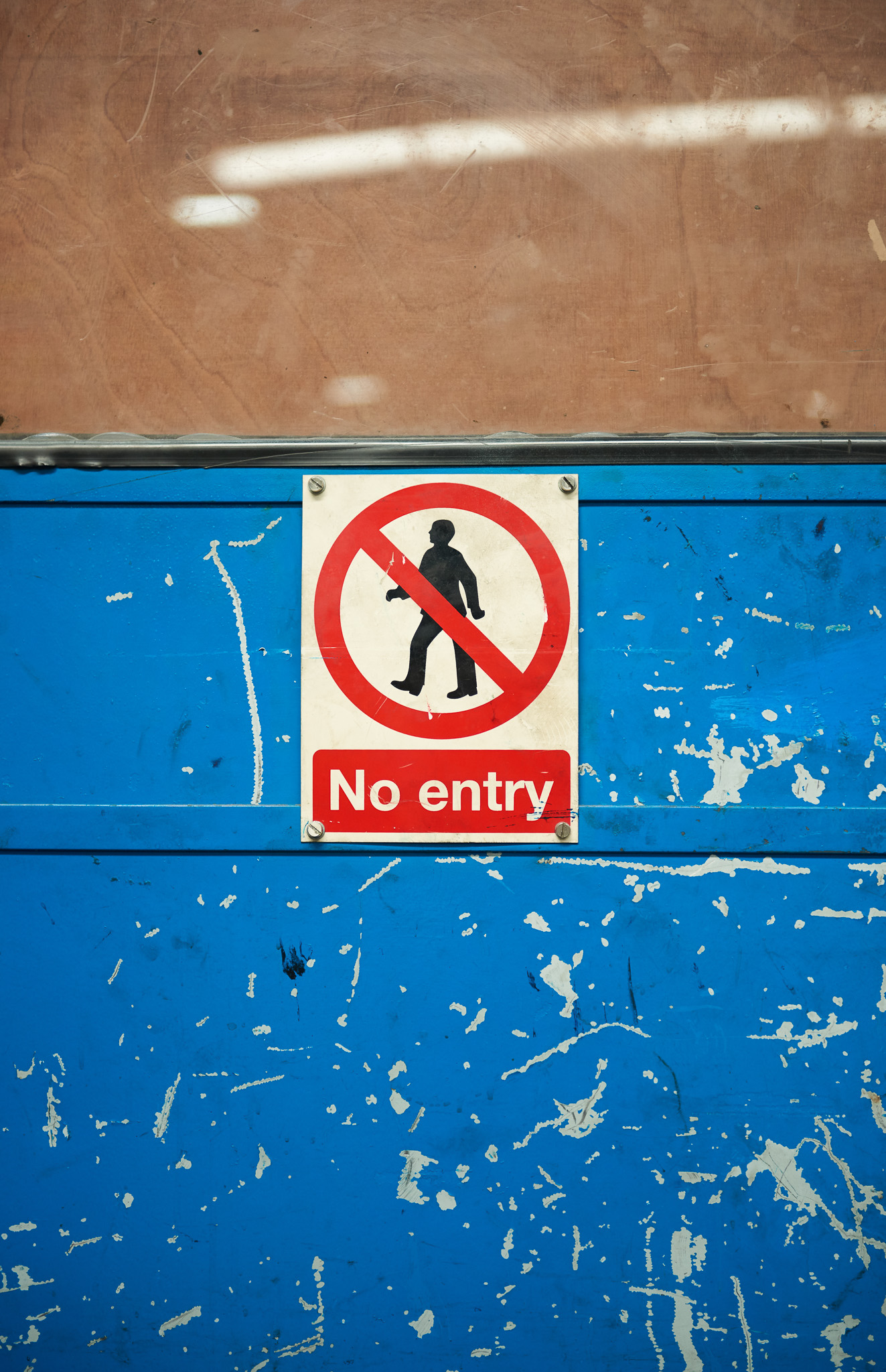 A weathered, vibrant blue wall with a 