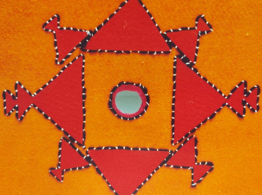 A symmetrical red geometric design with triangles and arrow shapes surrounds a blue circle, all outlined in black and white, set against an orange background.
