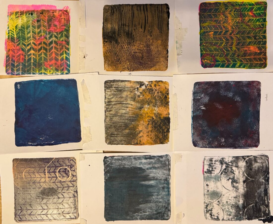 Nine abstract square prints on paper, arranged in a 3x3 grid. Each print features different textures, patterns, and colours, including bright hues, earthy tones, and muted shades. Background is a warm, neutral surface.