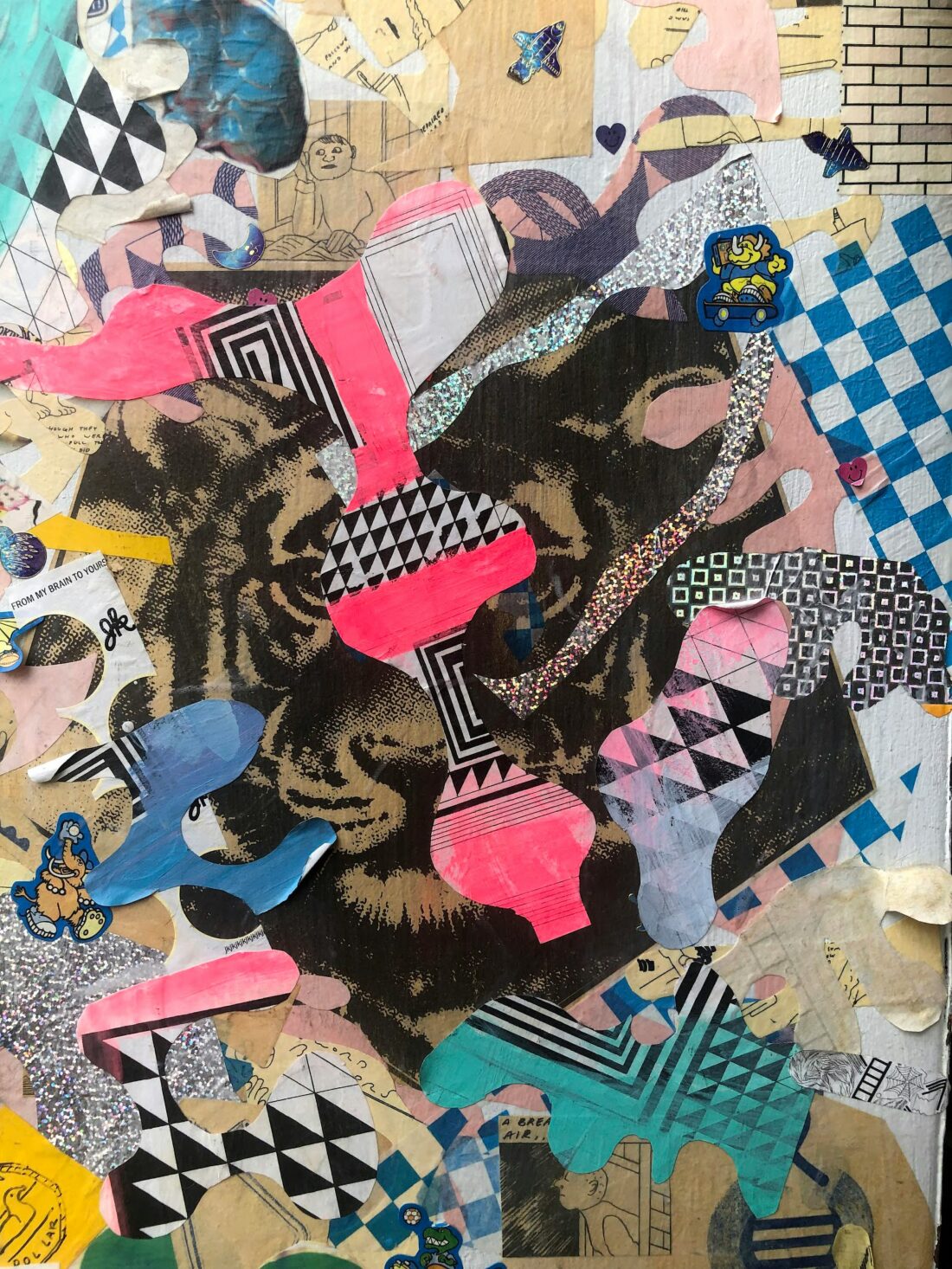 A collage featuring a tiger's face in the centre, surrounded by colourful abstract shapes, patterns, stickers, and layered paper cut-outs, creating a visually dynamic and textured artwork.